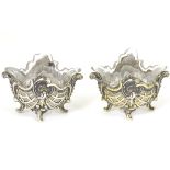 A pair of Continental .800 silver salts with gilded detail and shaped glass liners.