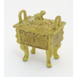 A Chinese rectangular censer with a yellow ground, raised on 4 paw footed legs,