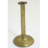 A 19thC brass candlestick with a spun base. Approx.