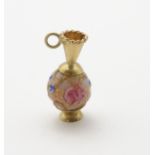 A 9ct gold charm formed as a ewer with a Venetian bead formed body.