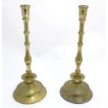 A pair of 19thC Continental cast and turned brass candlesticks, with bases reminiscent of Heemskerk,