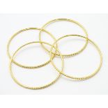 4 yellow metal bangle bracelets. Probably Indian.