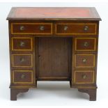 An early 20thC mahogany kneehole desk,