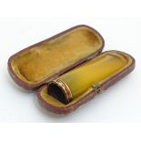 A cheroot mouthpiece of faux amber, contained within a leather case, 2 1/4 long.