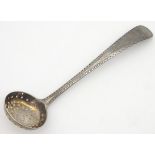 An 18thC silver spice sifting spoon of ladle form with pierced bowl. London 1784.