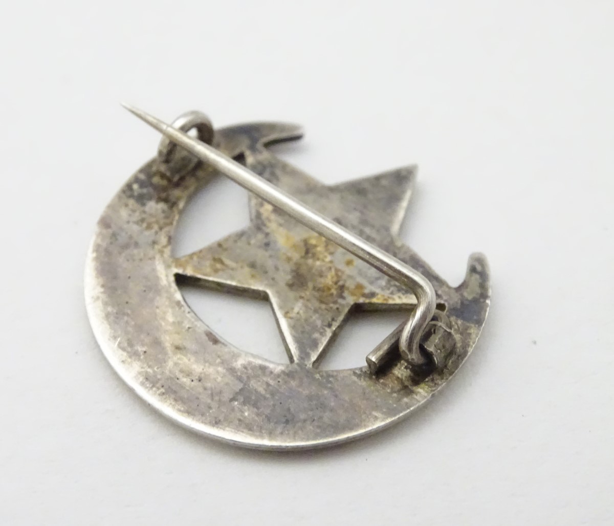 A white metal brooch formed as a crescent moon and star with damascene decoration titled ' Florrie - Image 4 of 7