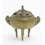A Chinese three footed brass lidded censer with tailed animal side handles ,