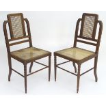 A pair of oak Aesthetic movement chairs with unusual shaped backs,
