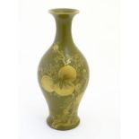 A Chinese tea dust glaze vase with gilt fruit, bat and branch decoration. Character marks under.