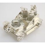 A 21stC silver plated novelty cruet set, formed as an early motor car.