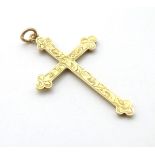 A 9ct gold cross formed pendant with engraved decoration.
