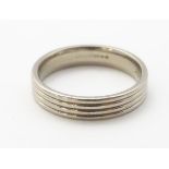 An 18ct white gold ring with reeded detail, inspired by the work of HG Murphy.