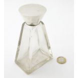 A silver topped perfume bottle flask of triangular form with conical shaped silver top hallmarked