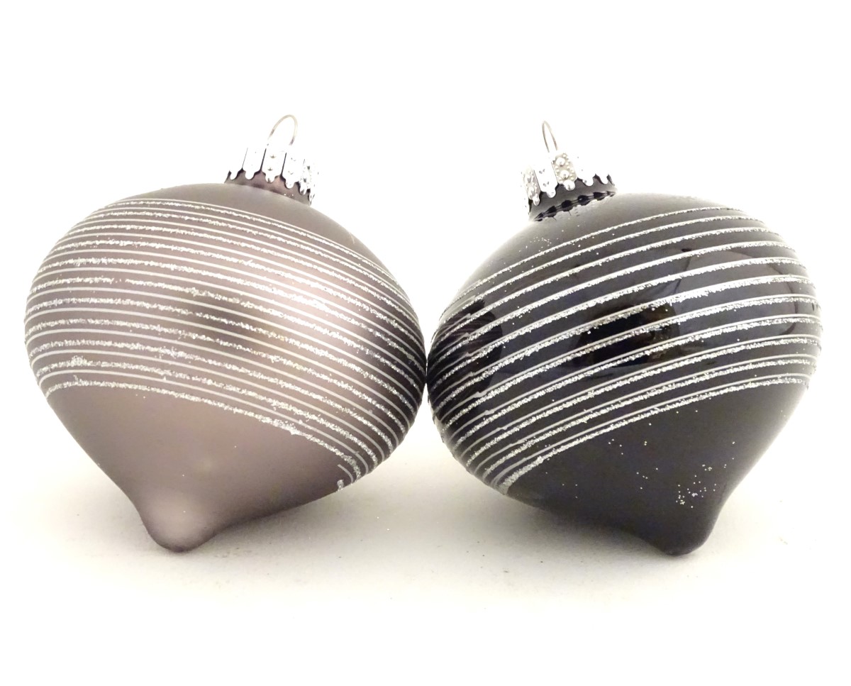 Christmas decorations : two glass baubles one grey the other black.