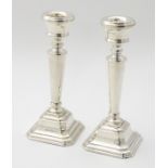 A pair of silver candlesticks hallmarked Birmingham 1996 maker L J Millington.