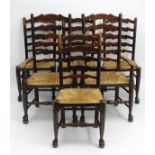 A set of six 19thC oak dining chairs with ladder backs and envelope rush seats,