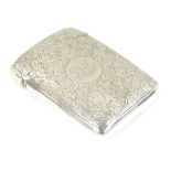A silver cigarette case of shaped form with engine turned decoration.