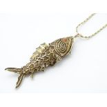 A silver gilt vinaigrette of pendant articulated fish form with filigree decoration.