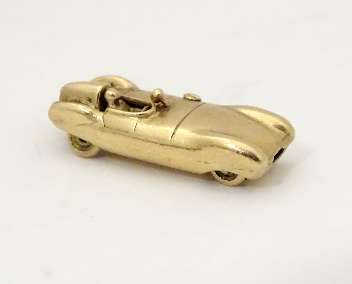 A gold vintage pendant / charm formed as an early racing car 1 1/8" long CONDITION: