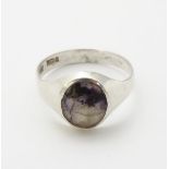 A Gentleman's silver signet ring set with Blue John cabochon. Hallmarked 1976 maker R W Wingate Ltd.