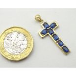 A 9ct gold cross formed pendant set with 7 topaz.