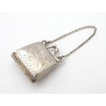 A novelty silver pill box / vinaigrette formed as a lady's miniature bag / purse.