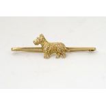 A 9ct gold bar brooch / pin with image of a terrier dog to centre 2 1/2" wide CONDITION:
