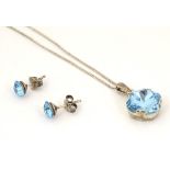 A white metal pendant set with aquamarine coloured stone approx 1/2" wide on a silver chain
