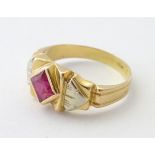 An 18ct gold ring set with central ruby in an Art Deco style setting.