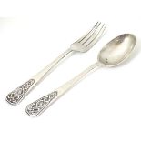 A silver christening spoon and fork with Celtic decoration to handles.