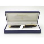 A cased fountain pen by Waterman, Paris, with black and gilt finish, gold nib marked '18k 750.