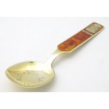 A Norwegian silver gilt 'Bergen' souvenir / commemorative spoon with guilloche enamel decoration to