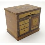 A 19thC continental moneybox, formed as a miniature cupboard, with various contrasting inlays,