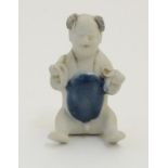 An 18thC Chinese porcelain figure of a naked boy seated with his legs stretched forward and his