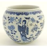 A blue and white Oriental jardiniere, decorated with figures in traditional dress and flowers.
