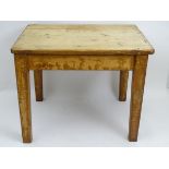 A Victorian pine table with a rectangular top above four tapering legs.