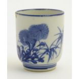 A Japanese blue and white pot with hand painted floral and foliate decoration.