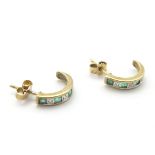 A pair of 9ct gold earrings set with diamonds and emeralds.