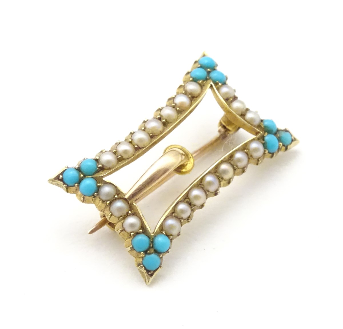A late 19thC / early 20thC 15ct gold buckle formed brooch set with turquoise and seed pearl.