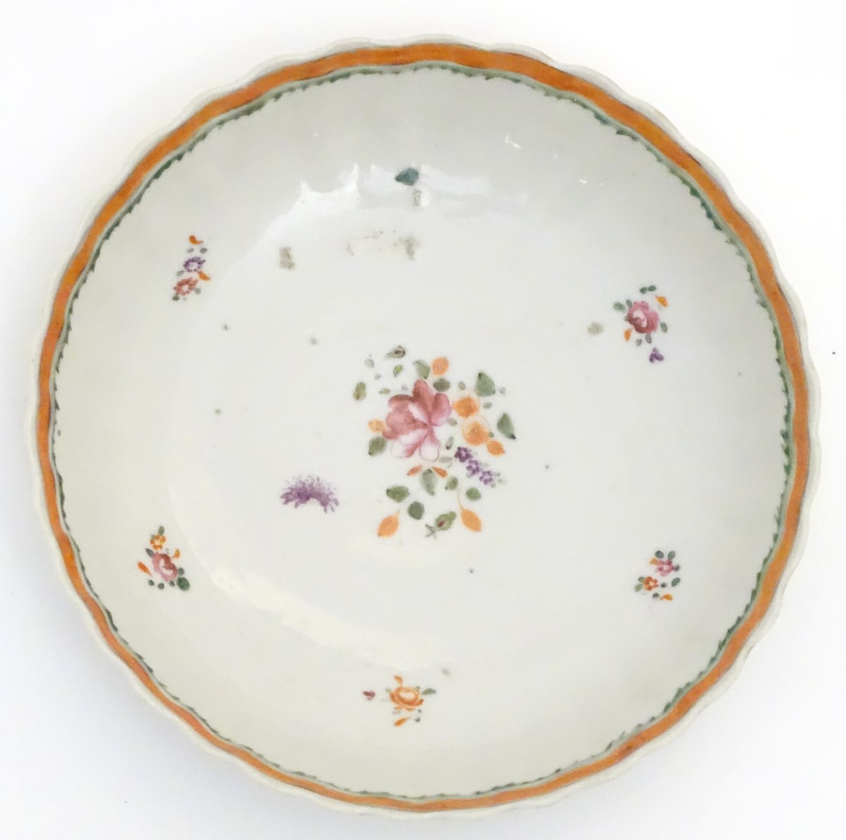 A scallop edge dish with hand painted floral decoration. Approx. 6" diameter.