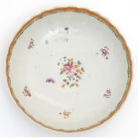 A scallop edge dish with hand painted floral decoration. Approx. 6" diameter.