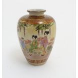 A small Japanese satsuma vase depicting figures in a garden, with gilt highlights.
