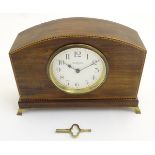 An Edwardian mantle clock, having a continental movement, the enamelled dial signed 'R.H.
