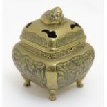 A Chinese brass censer of squared form with chased decoration to side panels and having 4 hoof