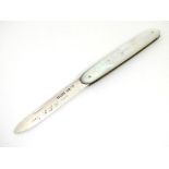 A silver pen knife with mother of pearl handle having engraved floral decoration.