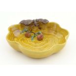 A Chinese wavy edged yellow brush wash dish with bat and fruit decoration,