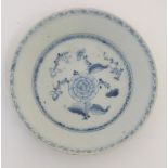 An 18thC Chinese blue and white plate, with hand painted floral decoration.
