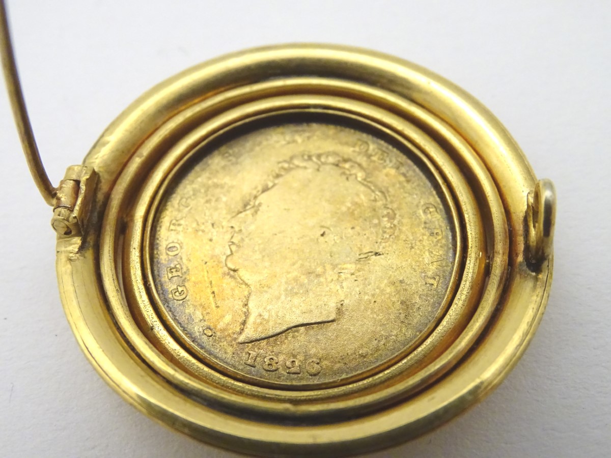 A 19thC brooch set with oval rotating Geo IV 1826 coin with enamelled decoration to one side. - Image 2 of 7