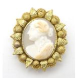 A 19thC Cameo brooch set with central classical cameo within a two colour yellow metal mount 1 1/2"