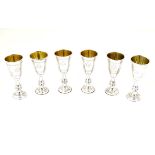 A set of 6 silver kiddush cups with engraved decoration and gilded interior.